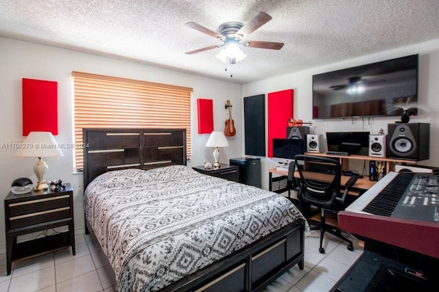 bedroom featuring ceiling fan, light tile patterned floors, and a textured ceiling