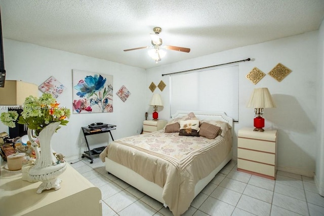 tiled bedroom featuring ceiling fan and a textured ceiling