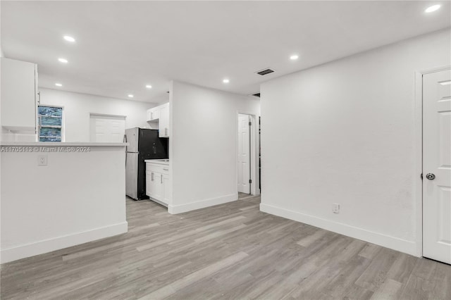 unfurnished living room with light hardwood / wood-style flooring