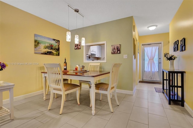 tiled dining space featuring rail lighting