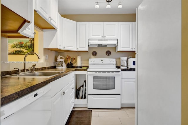 kitchen featuring white cabinets, light tile patterned floors, white appliances, and sink