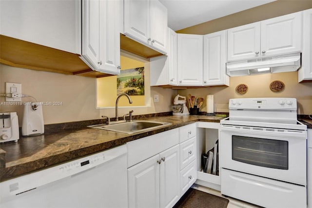 kitchen with white appliances, white cabinetry, and sink