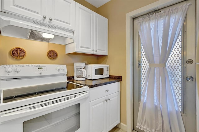 kitchen featuring white cabinets and white appliances