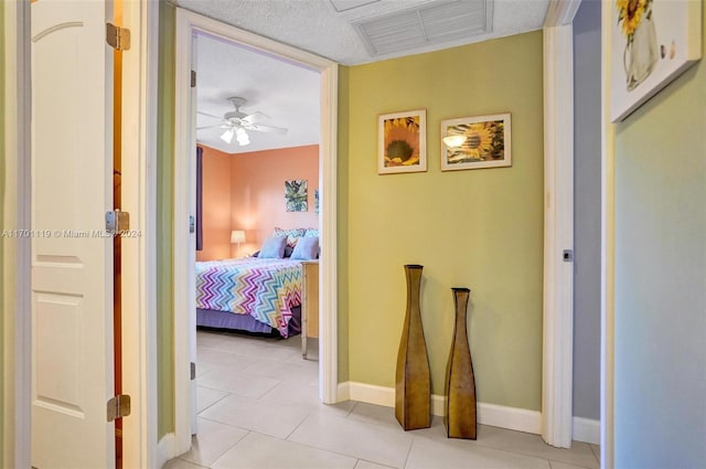 hall featuring light tile patterned floors