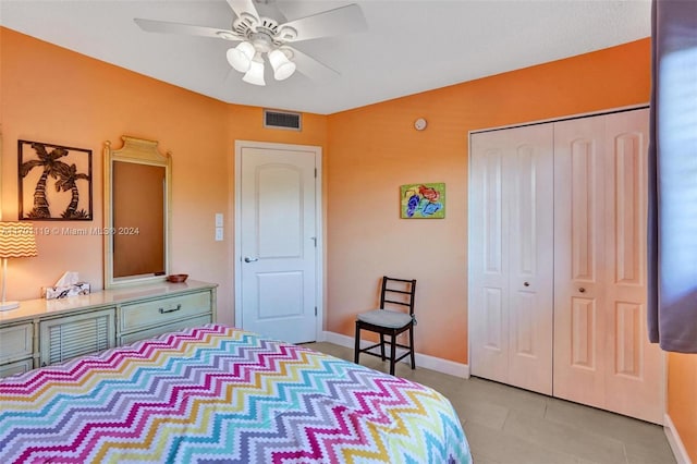 bedroom featuring light tile patterned floors, a closet, and ceiling fan