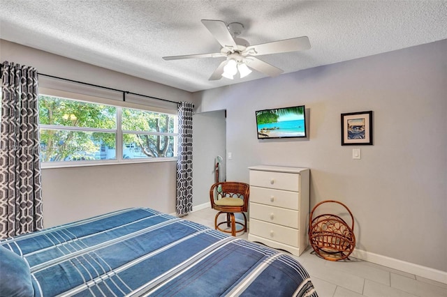 bedroom with a textured ceiling and ceiling fan