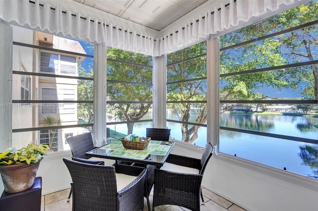 sunroom / solarium with a water view and plenty of natural light