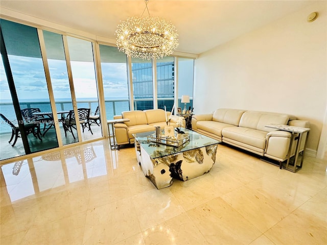 living room featuring a water view, floor to ceiling windows, and a notable chandelier