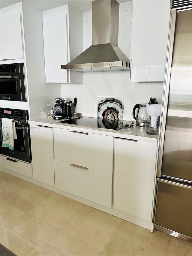 kitchen with backsplash, white cabinets, wall chimney exhaust hood, and appliances with stainless steel finishes