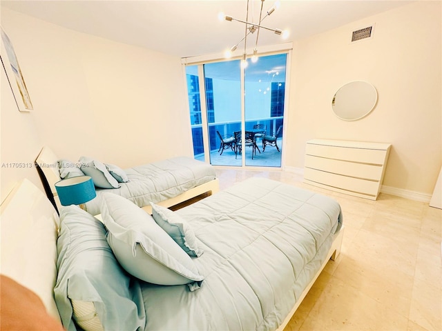 bedroom featuring access to outside and an inviting chandelier