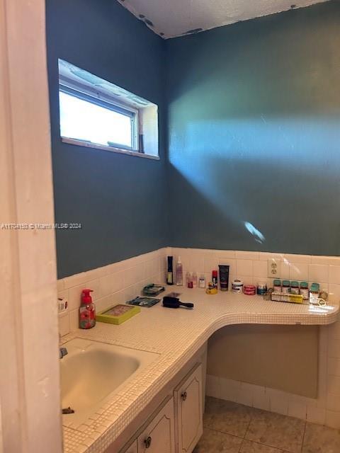 bathroom with tile patterned floors and sink