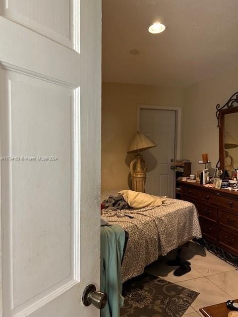 bedroom with light tile patterned flooring