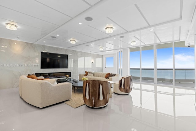 living room featuring tile patterned flooring, floor to ceiling windows, and a premium fireplace