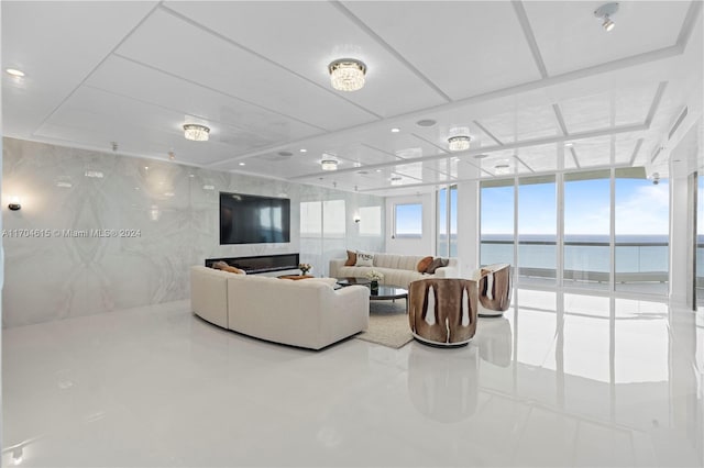 tiled living room featuring a wall of windows