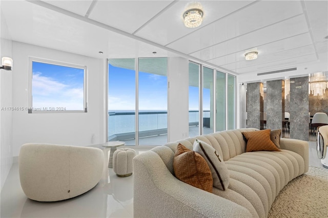 living room with a water view and a wall of windows