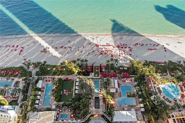 birds eye view of property featuring a beach view and a water view