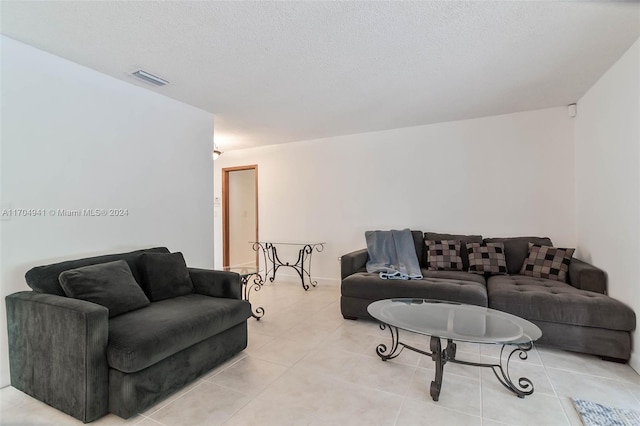 living room with light tile patterned floors and a textured ceiling