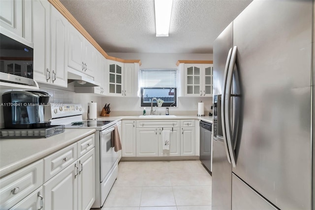 kitchen featuring white cabinetry, sink, stainless steel appliances, a textured ceiling, and light tile patterned floors