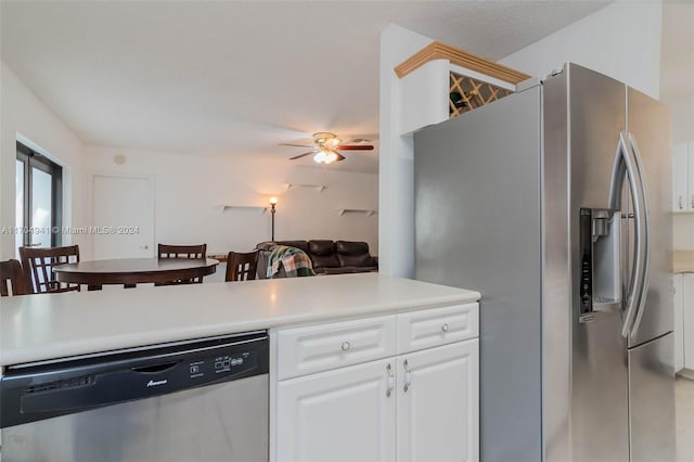 kitchen with ceiling fan, stainless steel appliances, kitchen peninsula, a textured ceiling, and white cabinets