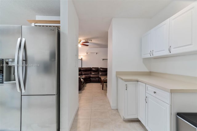 kitchen featuring ceiling fan, light tile patterned flooring, white cabinetry, and stainless steel refrigerator with ice dispenser