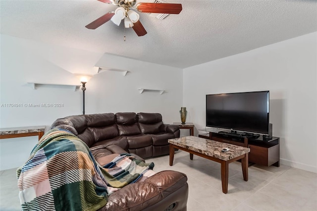 tiled living room with a textured ceiling and ceiling fan