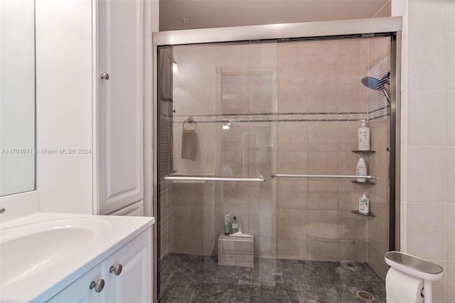 bathroom with vanity, toilet, and a shower with shower door