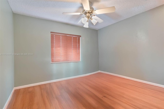 empty room with wood-type flooring, a textured ceiling, and ceiling fan