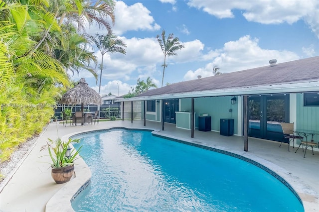 view of swimming pool with a patio area and french doors