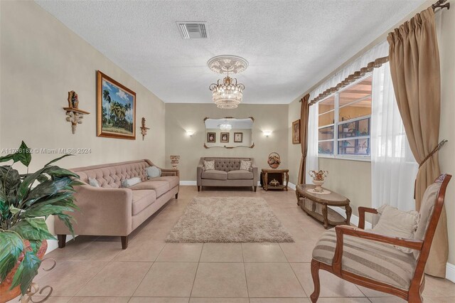 50 SW 130th Ave, Miami, FL 33184 - sitting room featuring light tile patterned flooring, a textured ceiling, and an inviting chandelier