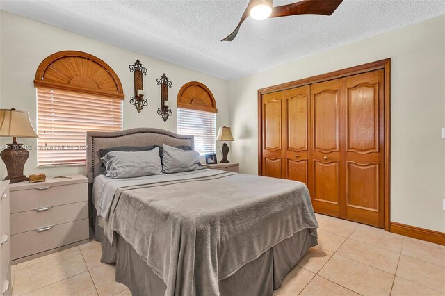 50 SW 130th Ave, Miami, FL 33184 - bedroom with ceiling fan, a closet, light tile patterned floors, and a textured ceiling