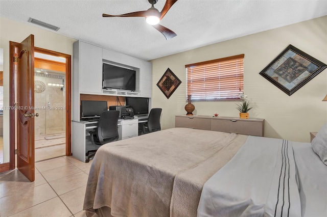50 SW 130th Ave, Miami, FL 33184 - tiled bedroom featuring a textured ceiling, ceiling fan, and connected bathroom
