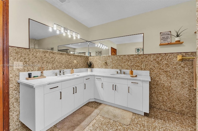 50 SW 130th Ave, Miami, FL 33184 - bathroom with a textured ceiling, vanity, and tile walls