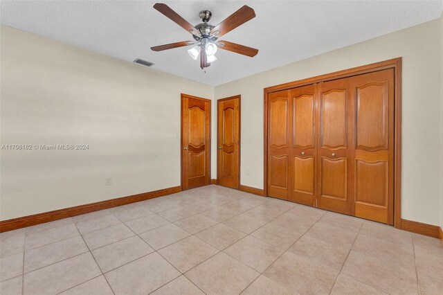50 SW 130th Ave, Miami, FL 33184 - unfurnished bedroom with light tile patterned floors, a textured ceiling, and ceiling fan