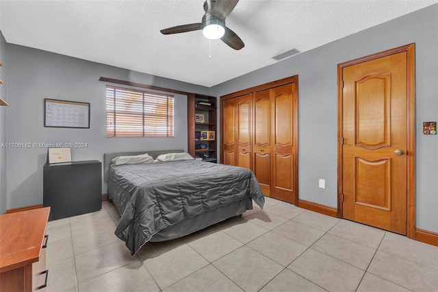 50 SW 130th Ave, Miami, FL 33184 - bedroom featuring light tile patterned floors, a textured ceiling, a closet, and ceiling fan