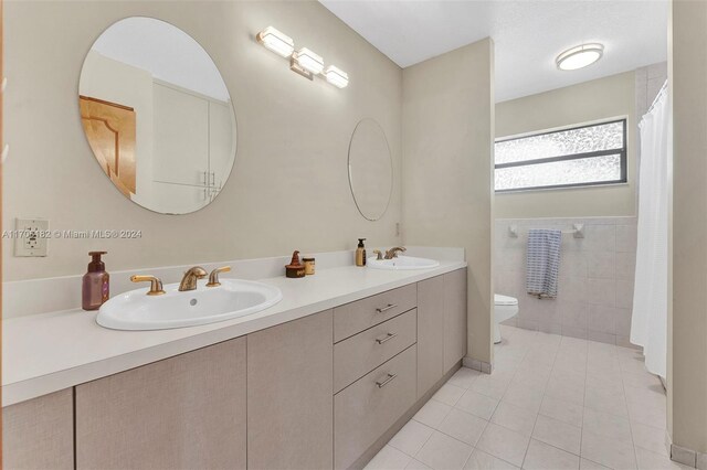 50 SW 130th Ave, Miami, FL 33184 - bathroom with tile patterned flooring, vanity, toilet, and tile walls