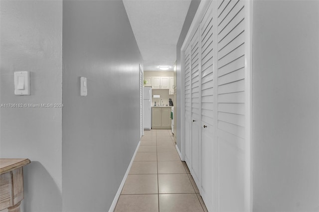 50 SW 130th Ave, Miami, FL 33184 - hallway with light tile patterned floors and a textured ceiling
