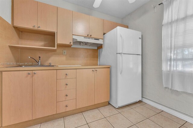 50 SW 130th Ave, Miami, FL 33184 - kitchen with light brown cabinetry, white fridge, light tile patterned floors, and sink