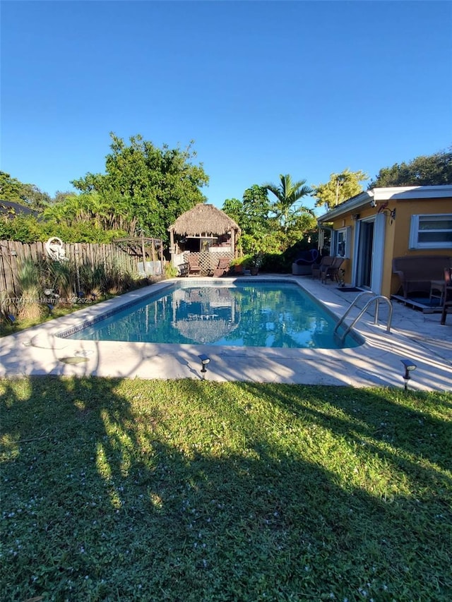 view of pool featuring a lawn, a gazebo, and a patio