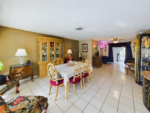 tiled dining area featuring ceiling fan