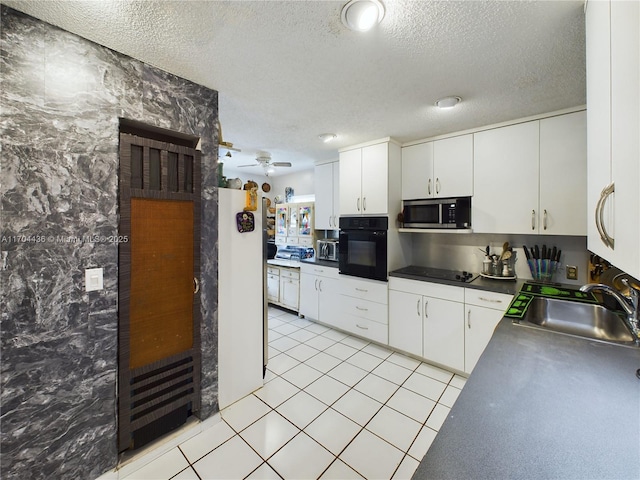 kitchen with black appliances, ceiling fan, sink, and white cabinetry