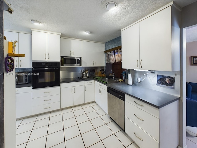 kitchen featuring tasteful backsplash, a textured ceiling, black appliances, white cabinets, and sink