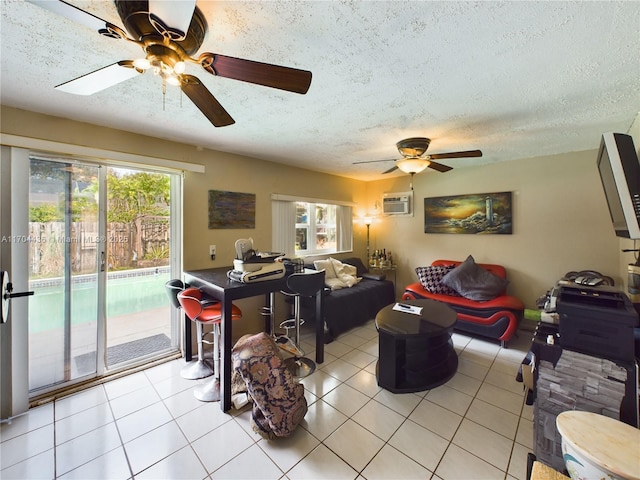 tiled living room with ceiling fan, a textured ceiling, and a wall mounted air conditioner