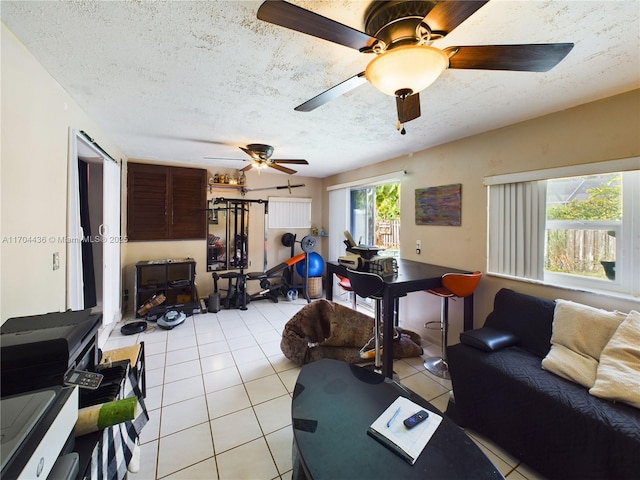 tiled living room featuring a textured ceiling