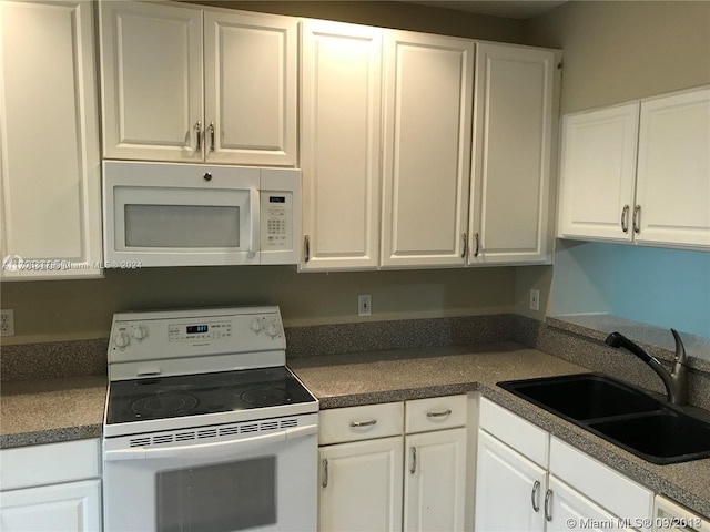 kitchen featuring white cabinetry, white appliances, and sink