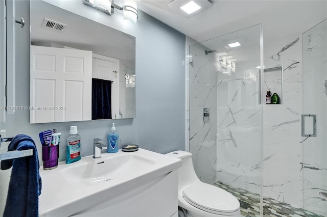 bathroom with toilet, a shower with door, and sink