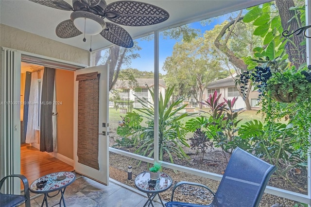 sunroom featuring ceiling fan