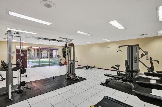 exercise room with light tile patterned floors