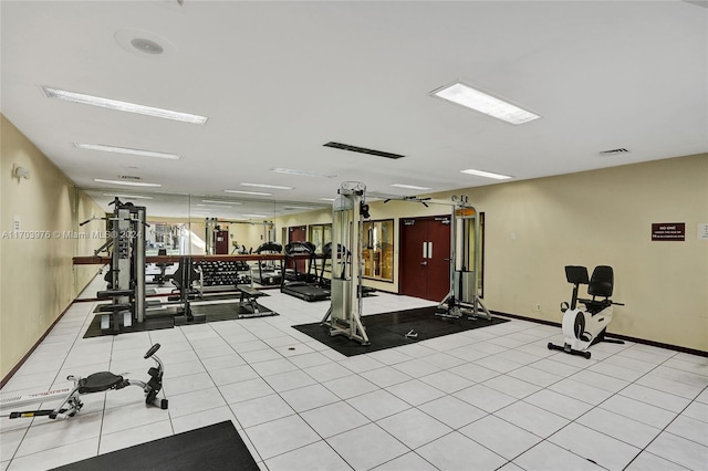 workout area with light tile patterned flooring