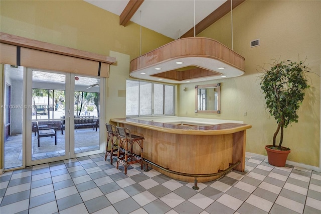 bar with beam ceiling, light tile patterned floors, high vaulted ceiling, and a hot tub