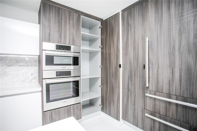 kitchen with double oven and light tile patterned floors